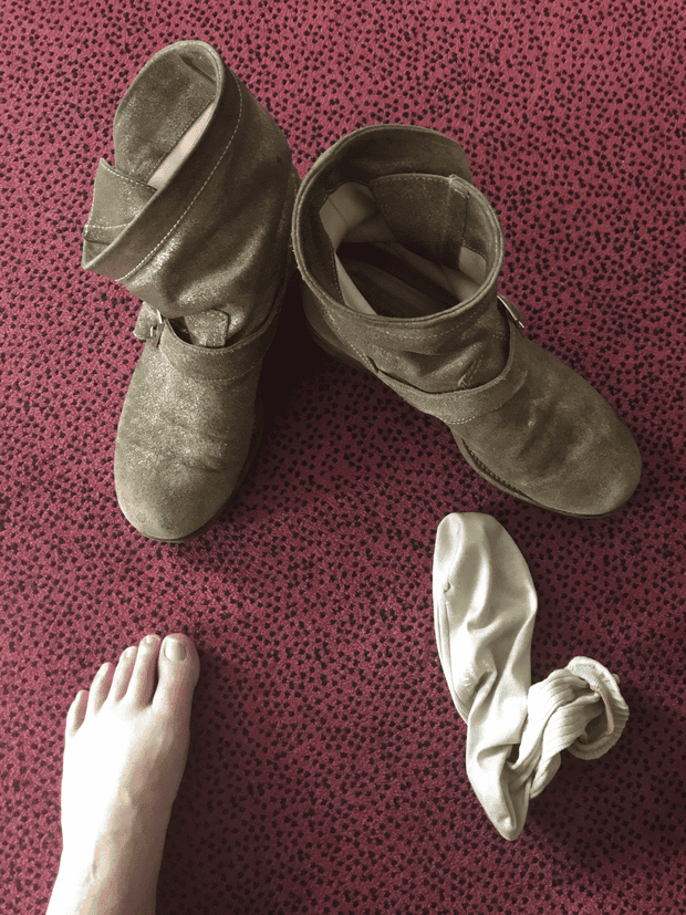 A photo by Patti Smith, of her boots and a sock, seen from above.
