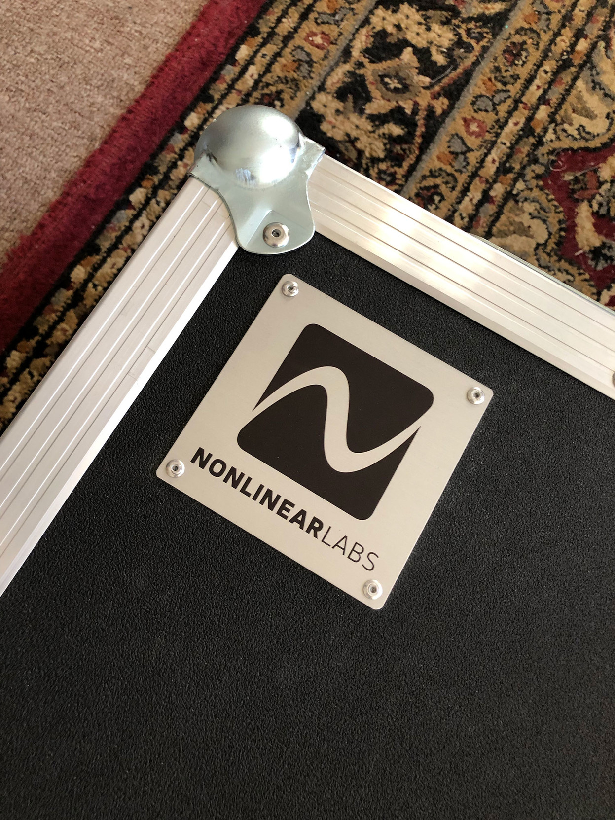 The Nonlinear Labs logo – a stylized sine wave cycle – on the C15’s flight case.