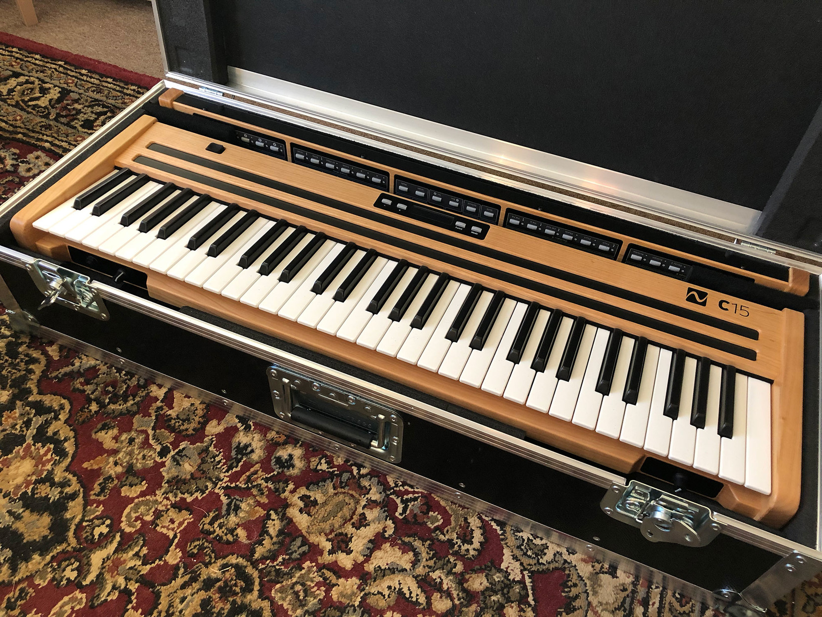 The case is open, and I get my first look at the new instrument. It’s beautiful, made of well-crafted cherry wood.