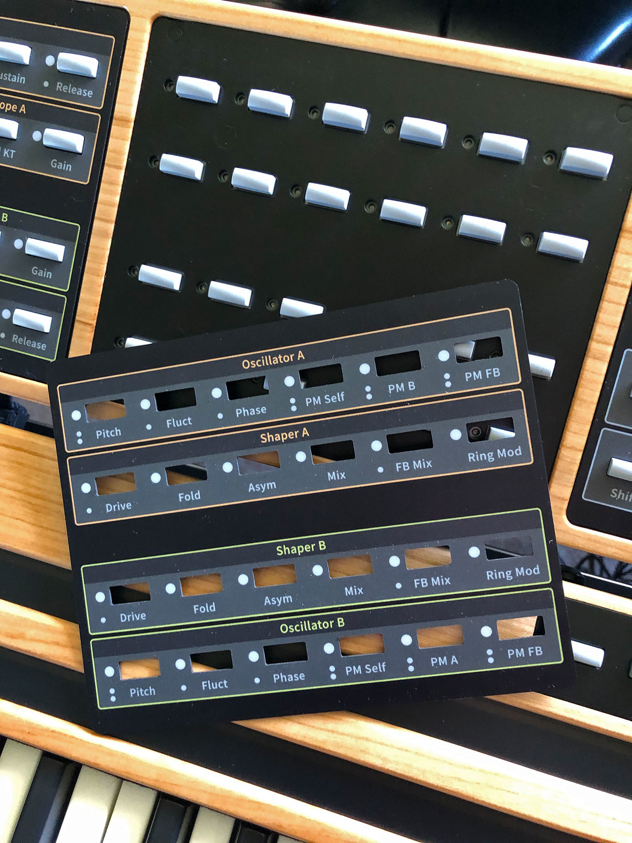 Closeup of a removable magnetic panel that allows button labels to be changed as new features are added.