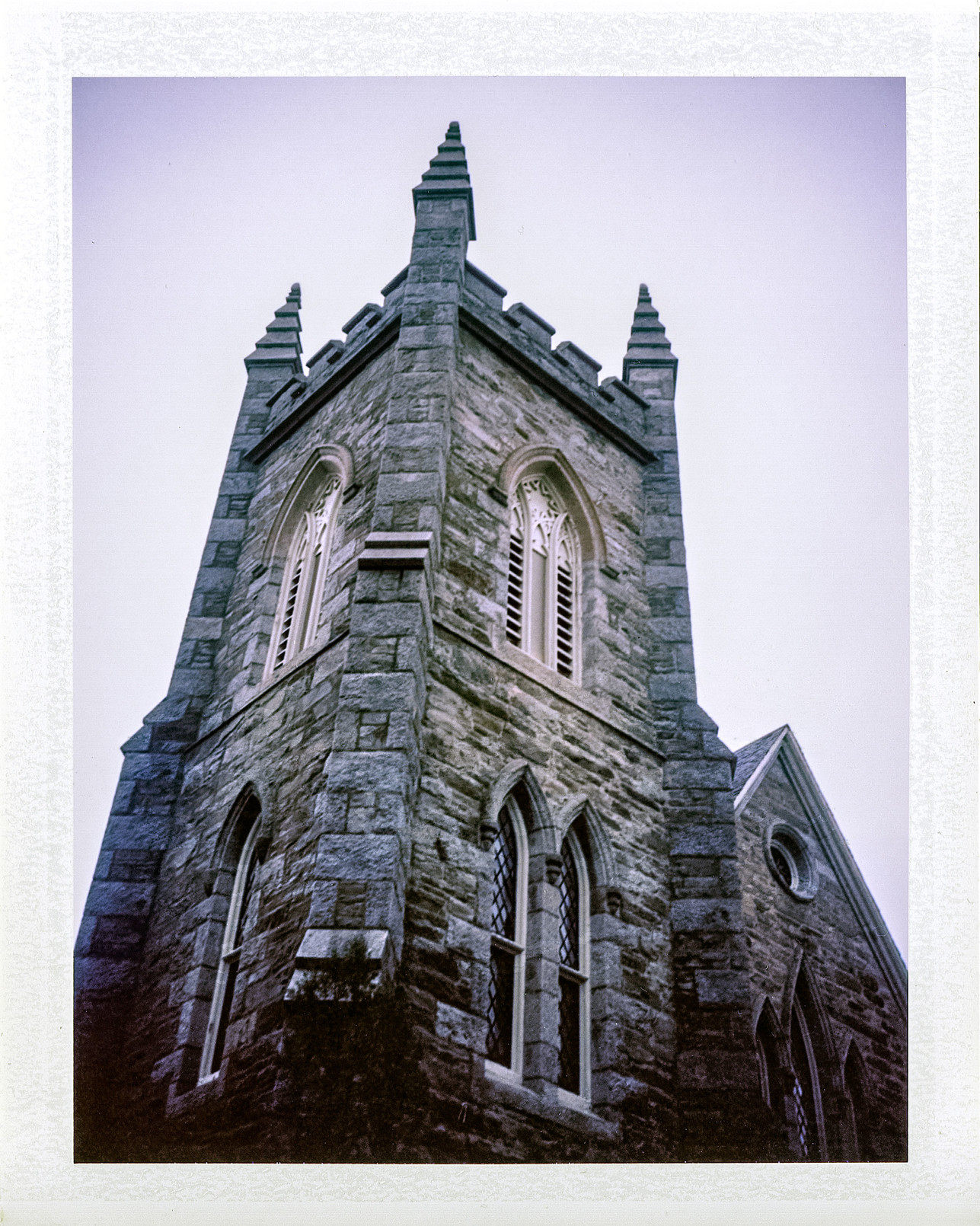 A Polaroid photo, taken with 11-year-old expired instant film, of the 167-year-old First Congregational Church clock tower in Bristol, RI.

It looms, in a gothic manner.