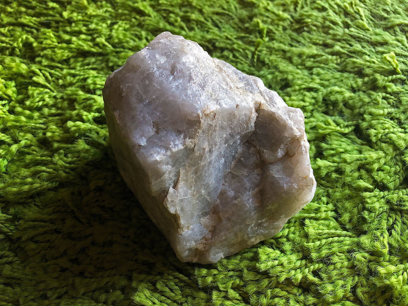 a 4" piece of quartz, sitting on a green shag carpet.