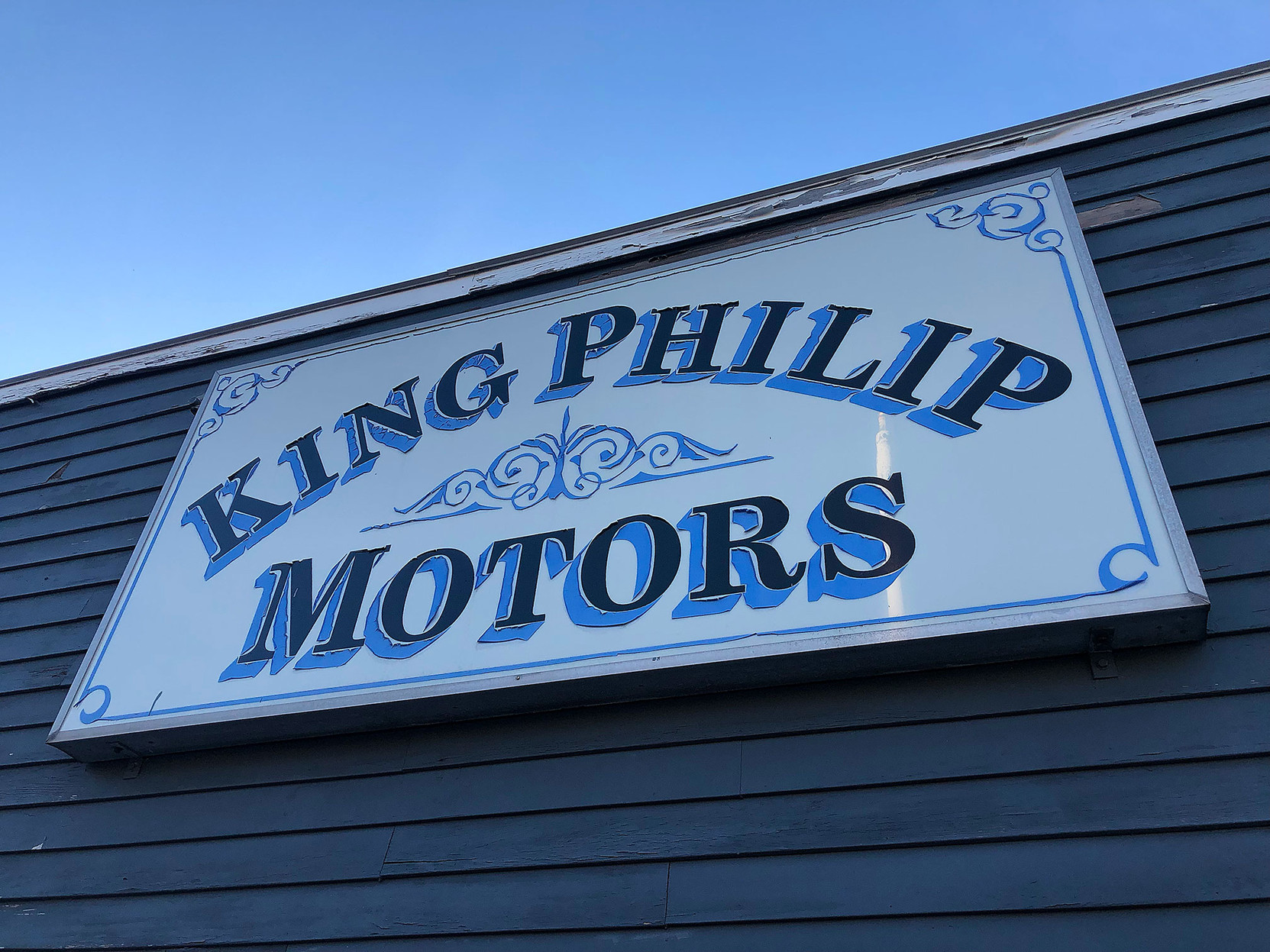 • a sign at a garage reading “King Philip Motors”