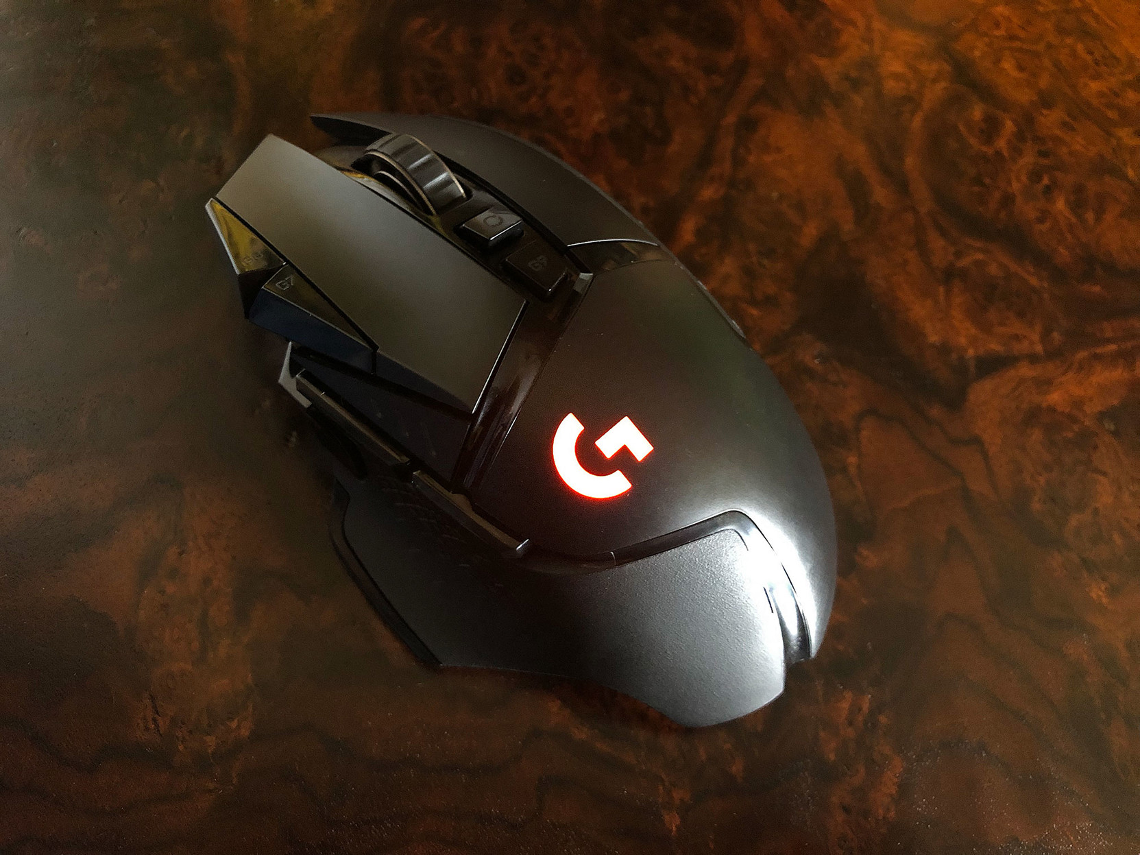 A very high-tech-looking Logitech gaming mouse, with lots of little buttons and a glowing logo.