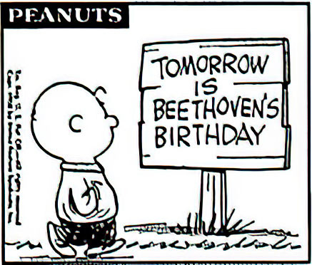 Charlie Brown is walking past a sign that says “Tomorrow is Beethoven’s Birthday”