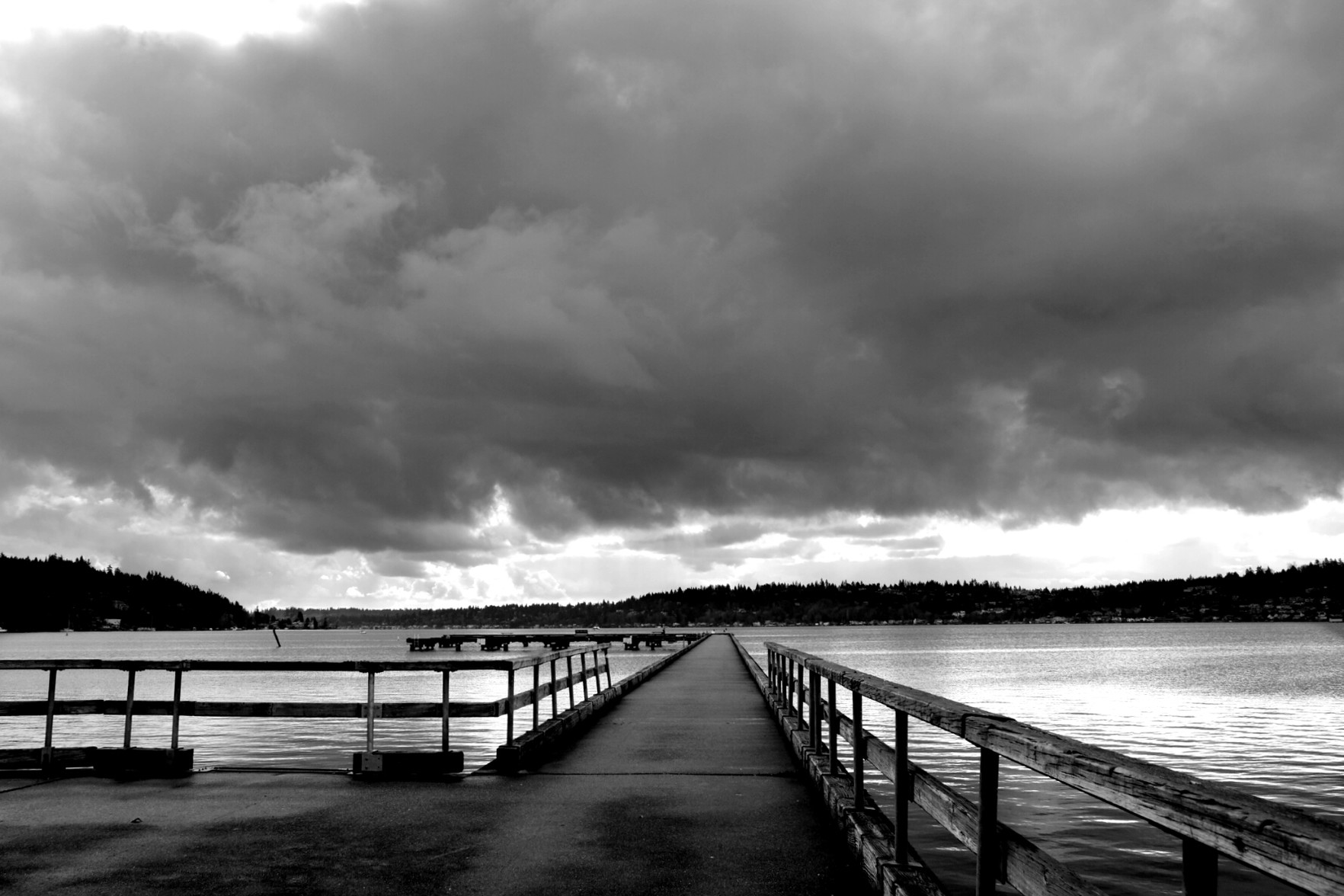 A long pier, under a dark and overcast sky near Seattle.