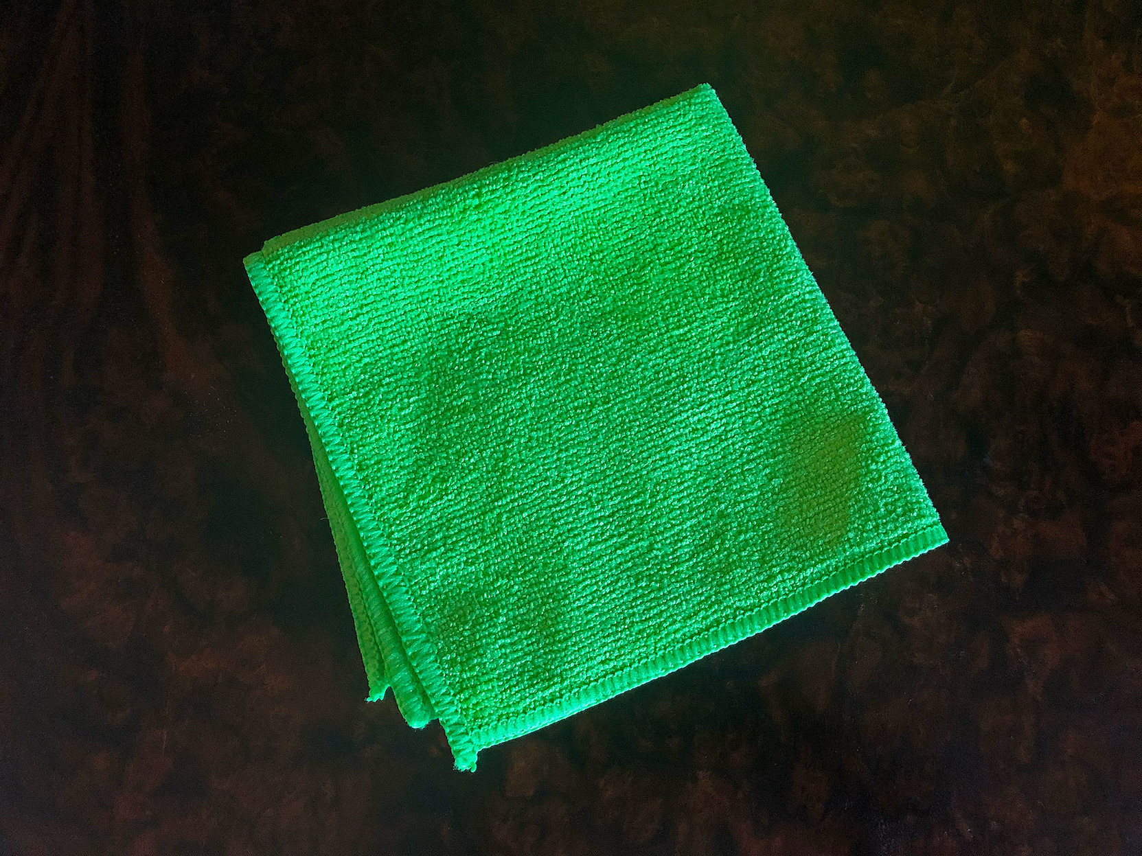 A little green microfiber cloth, folded neatly into a square.

It’s really a seriously intense shade of green.