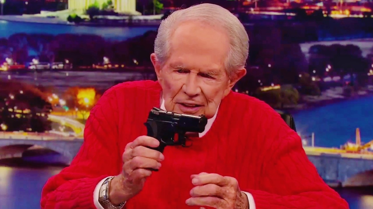 Pathetic waste of oxygen Pat Robertson in the studio, extorting funds from his audience “in the name of JEE-SUS!”

He’s waving a gun in the air in front of a montage of fire.