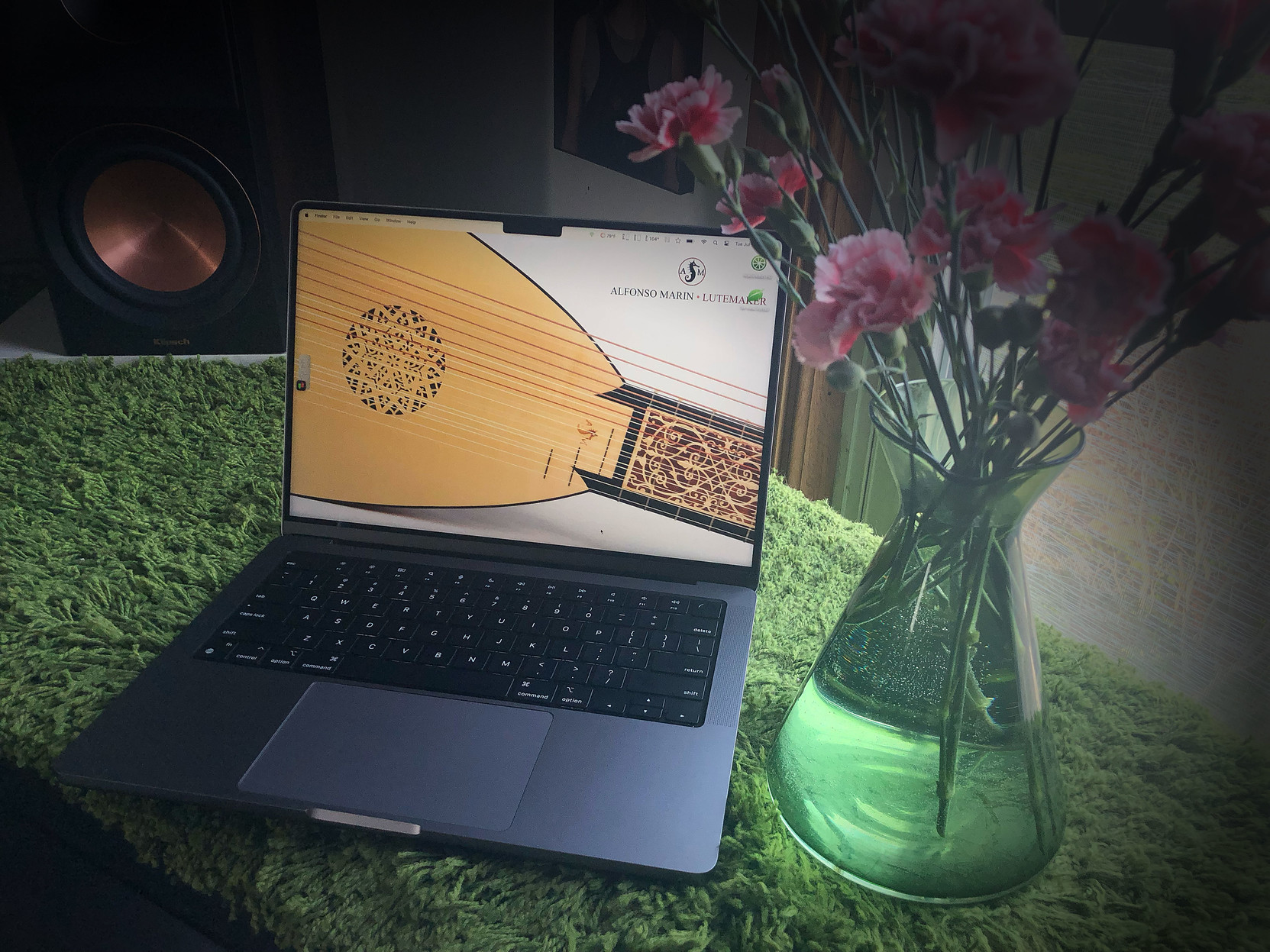 A lovely Space Gray MacBook Pro laptop, with multicolor carnations.