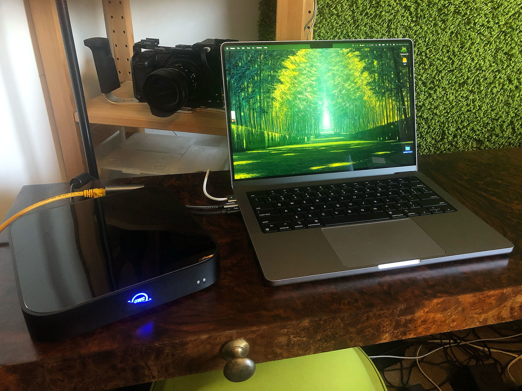 An OWC Ministack STX drive enclosure/Thunderbolt 4 port enclosure, sitting beside my dedicated live performance MacBook Pro M2 Max.