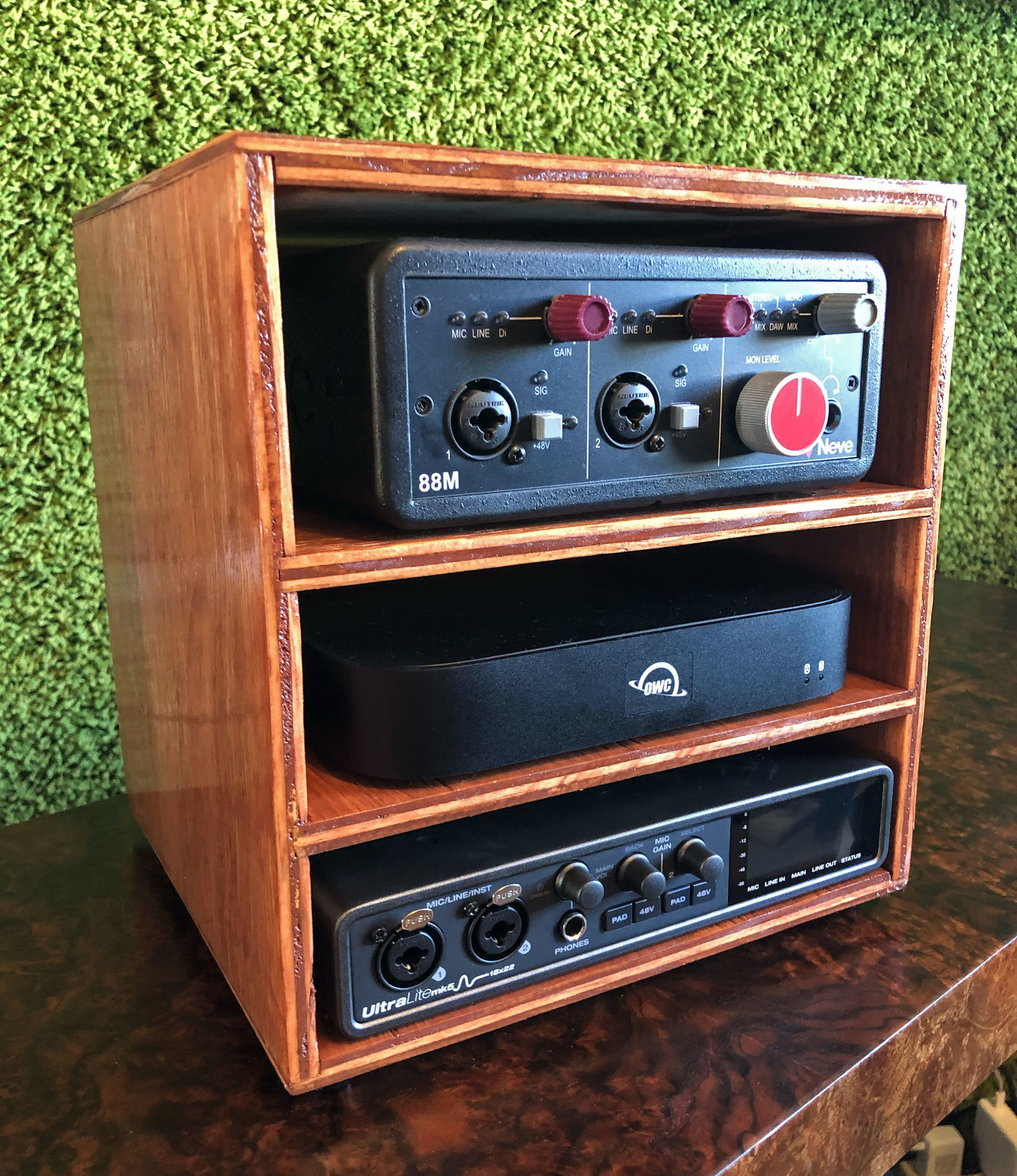 My three-tiered cubby for live performance. Made from scrap plywood, it holds three pieces of electronic gear for my live setup.