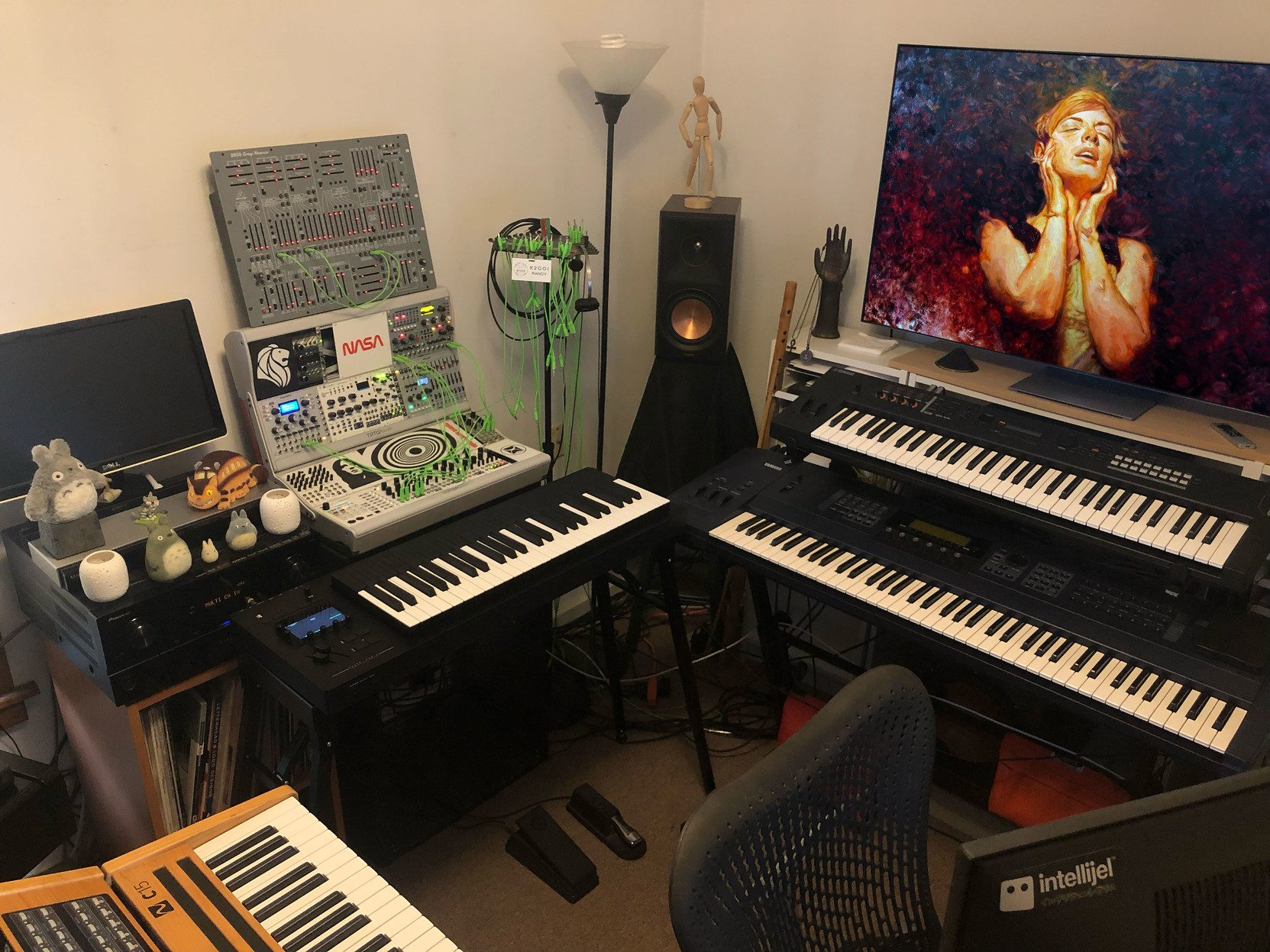 A circle of synthesizers, all at standing height … and the hero monitor in the studio’s front depicts a woman – clearly in a state of rapture with it all.