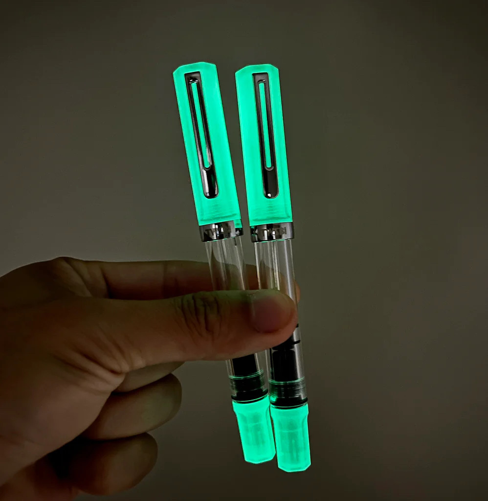 A pair of pens, magically glowing in the dark.