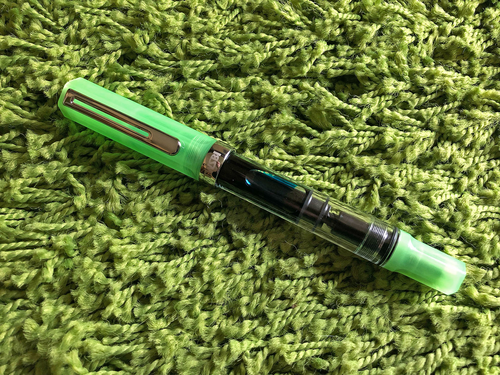My new TWSBI Eco Glo pen, on a field of green.

It’s filled with a very special ink by J. Herbin …