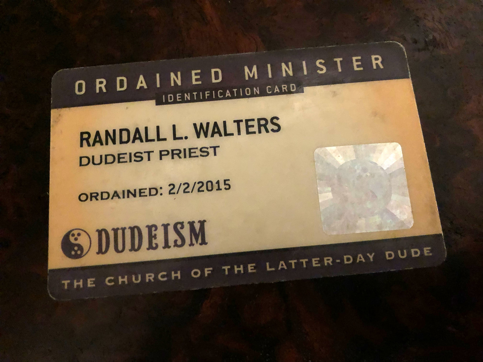 An ID card that says

“Ordained Minister

Randall L. Walters
Dudeist Priest
Ordained 2/2/2015

Dudeism
The Church of the Latter Day Dude”

(There’s a nice little bowling ball hologram, too.