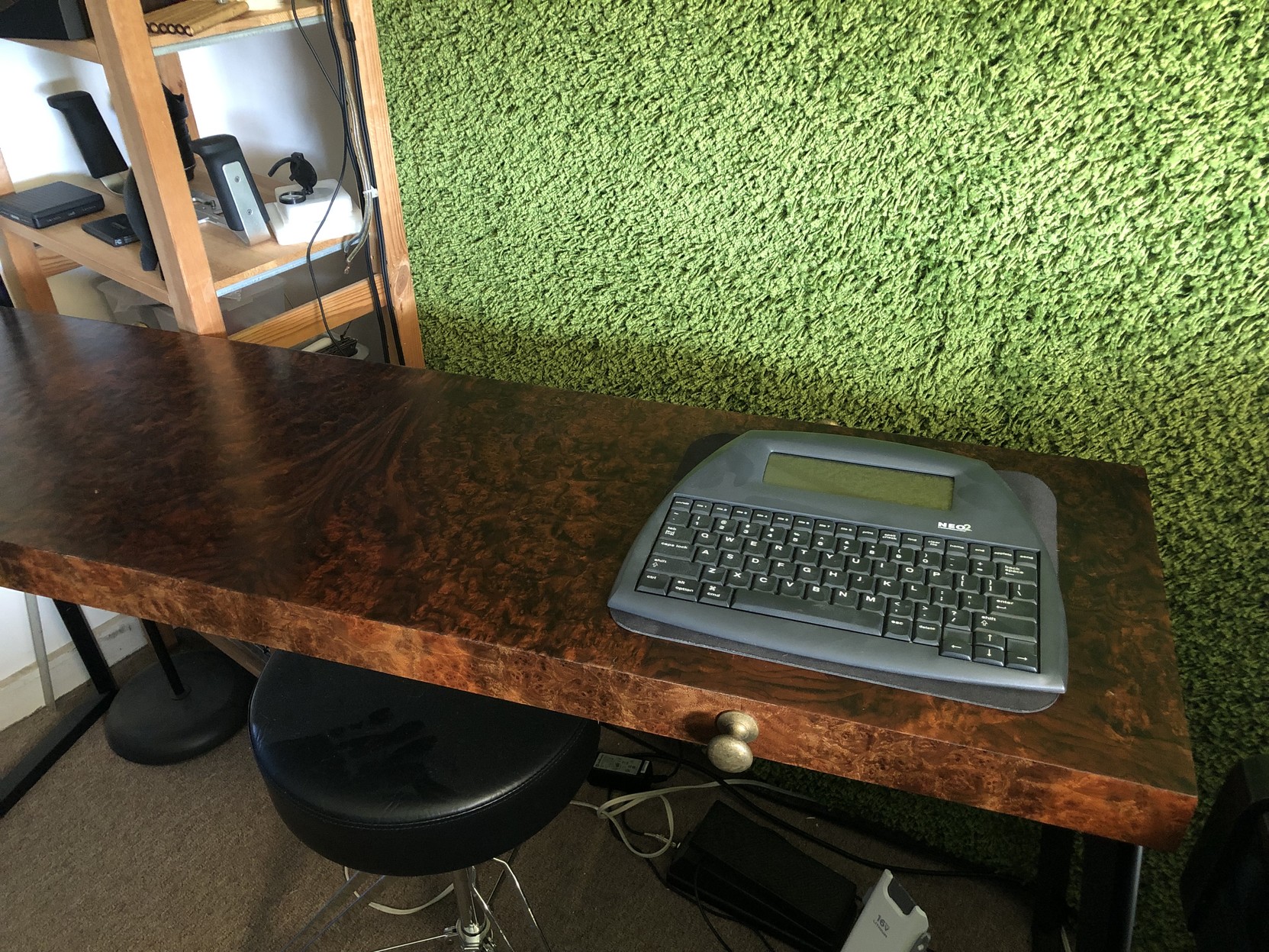 An Alphasmart Neo 2 word processor, sitting on the cover of my Seaboard Grand LFE.