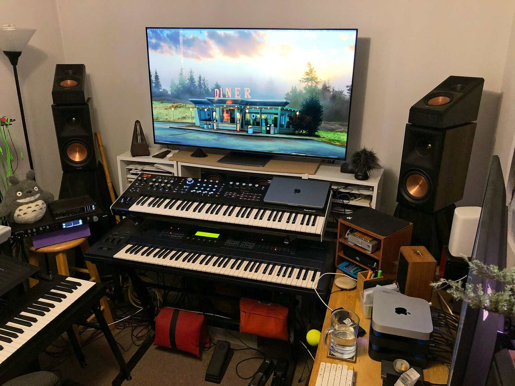 A pair of the new surround speakers, sitting on top of the existing front speakers.