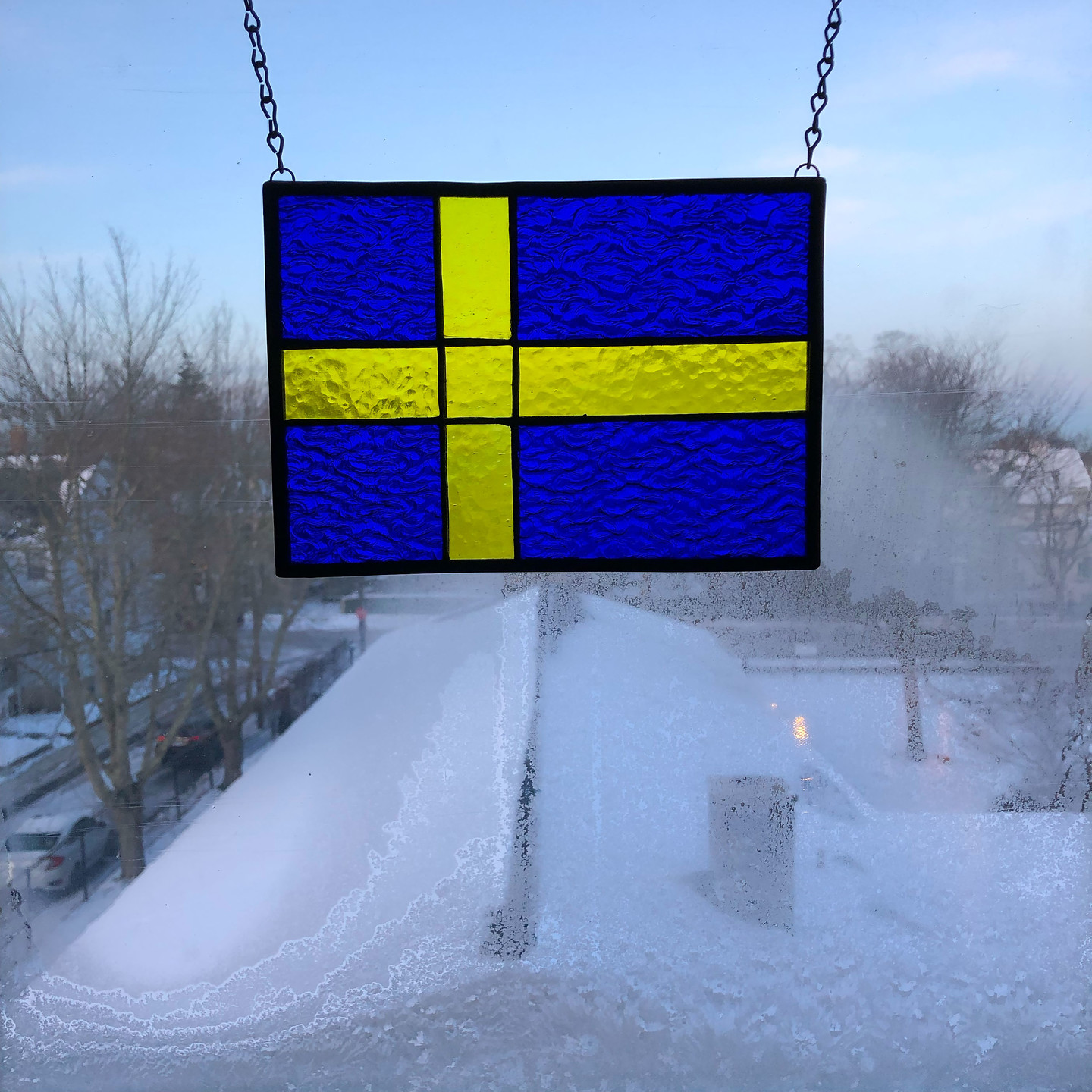 The beautiful Swedish flag in the window, framed by frost.