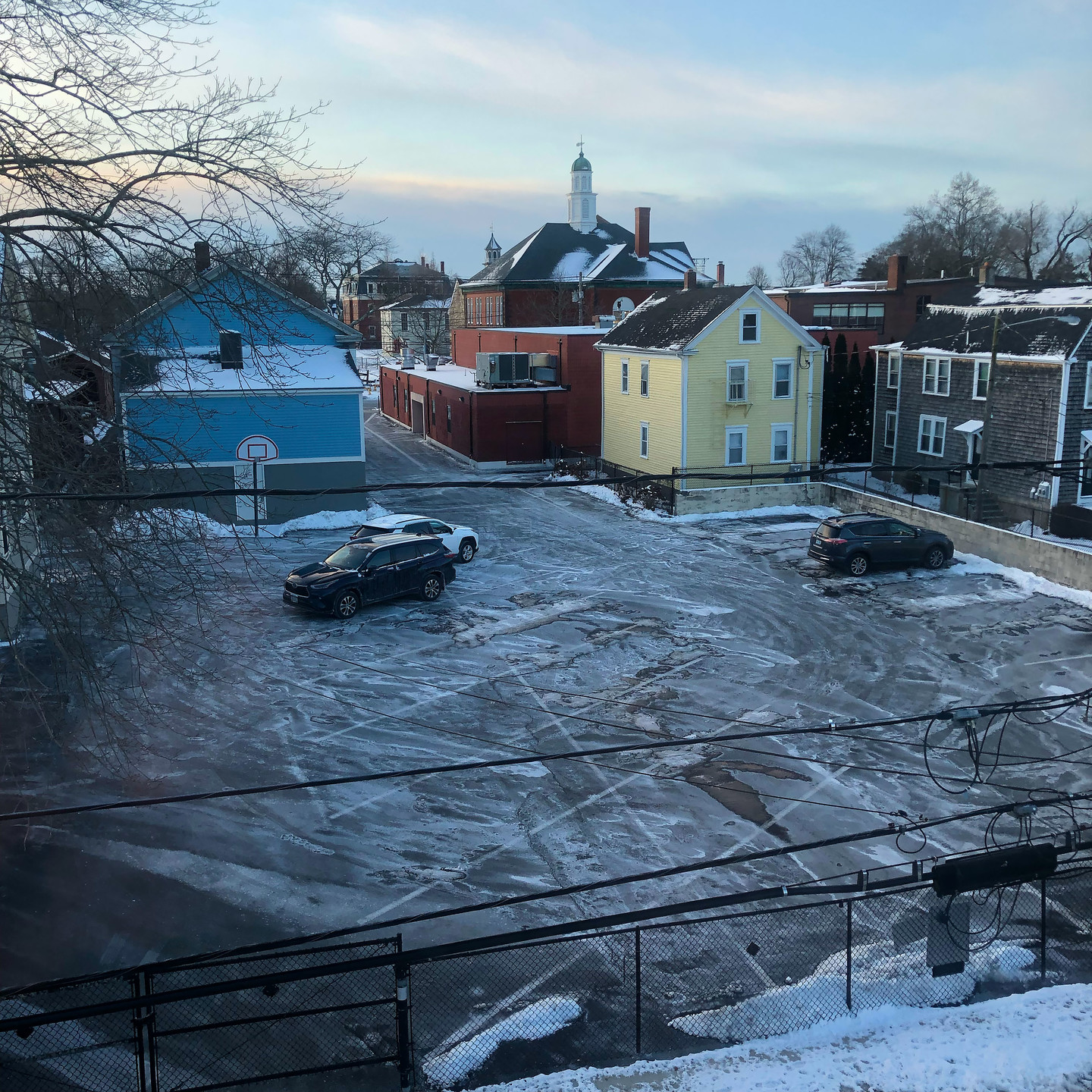 The church parking lot across the street from my living room, coated in ice and salt.