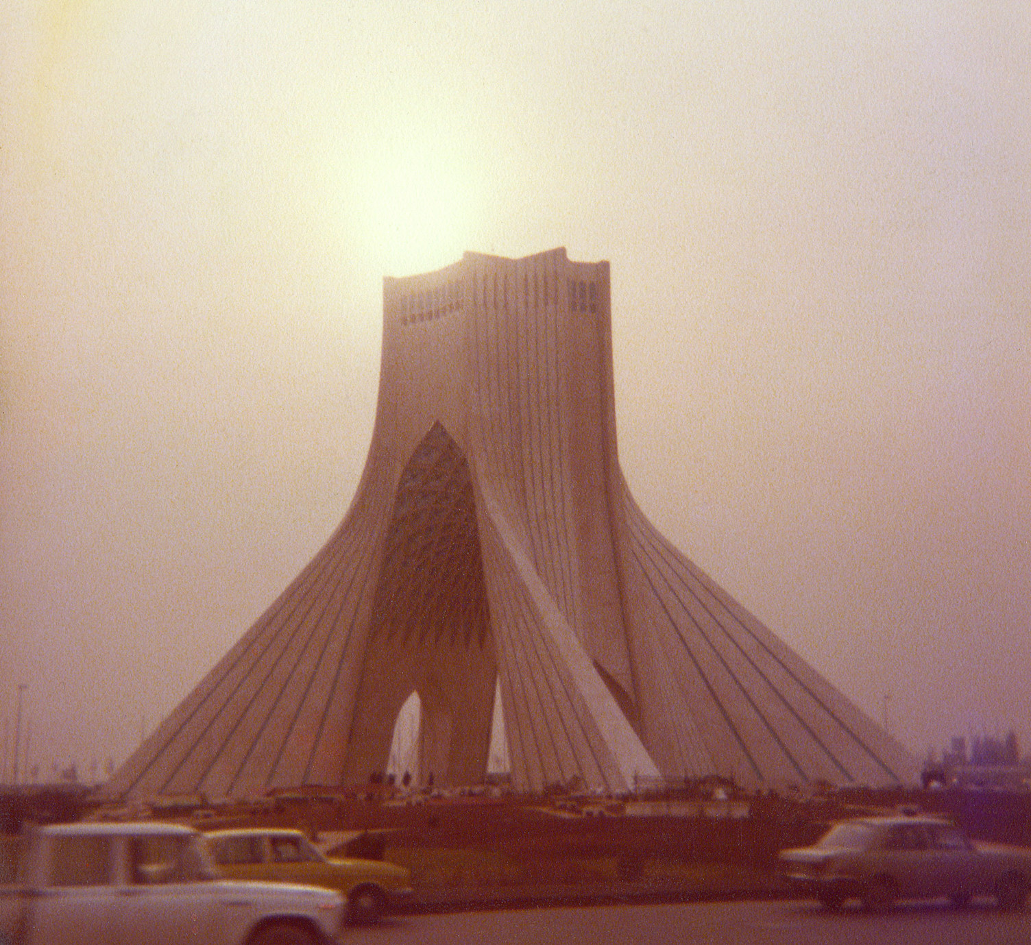The beautiful Azadi Tower, with the sun peeking out at the top through the smoggy Tehran sky. 

I terrified my parents getting this shot, but I had to do it. I remember feeling absolutely compelled, despite their protests. I believe I told them I had to do it.