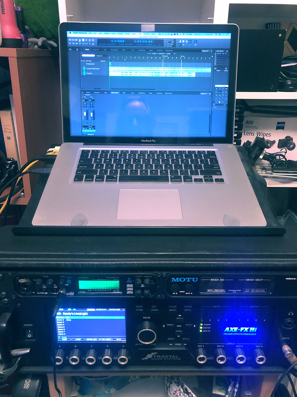 From the bottom up: Fractal Audio’s Axe-FX III, the finest dedicated guitar processor in the world, by far;

a MOTU audio interface and MIDI hub,

and the trusty (just one little dent) mid-2009 MacBook Pro, running the newest (!) version of MOTU’s Digital Performer. I record against a cue mix, and then send the guitar tracks across the hallway to the Atmos room via Ethernet.

It’s pretty amazing that a 16-year-old Mac can still run the latest software I need, and get the job done. My main room has two new Macs, but this one keeps chugging away, and it’s a luxury to have a dedicated laptop for the guitar space.