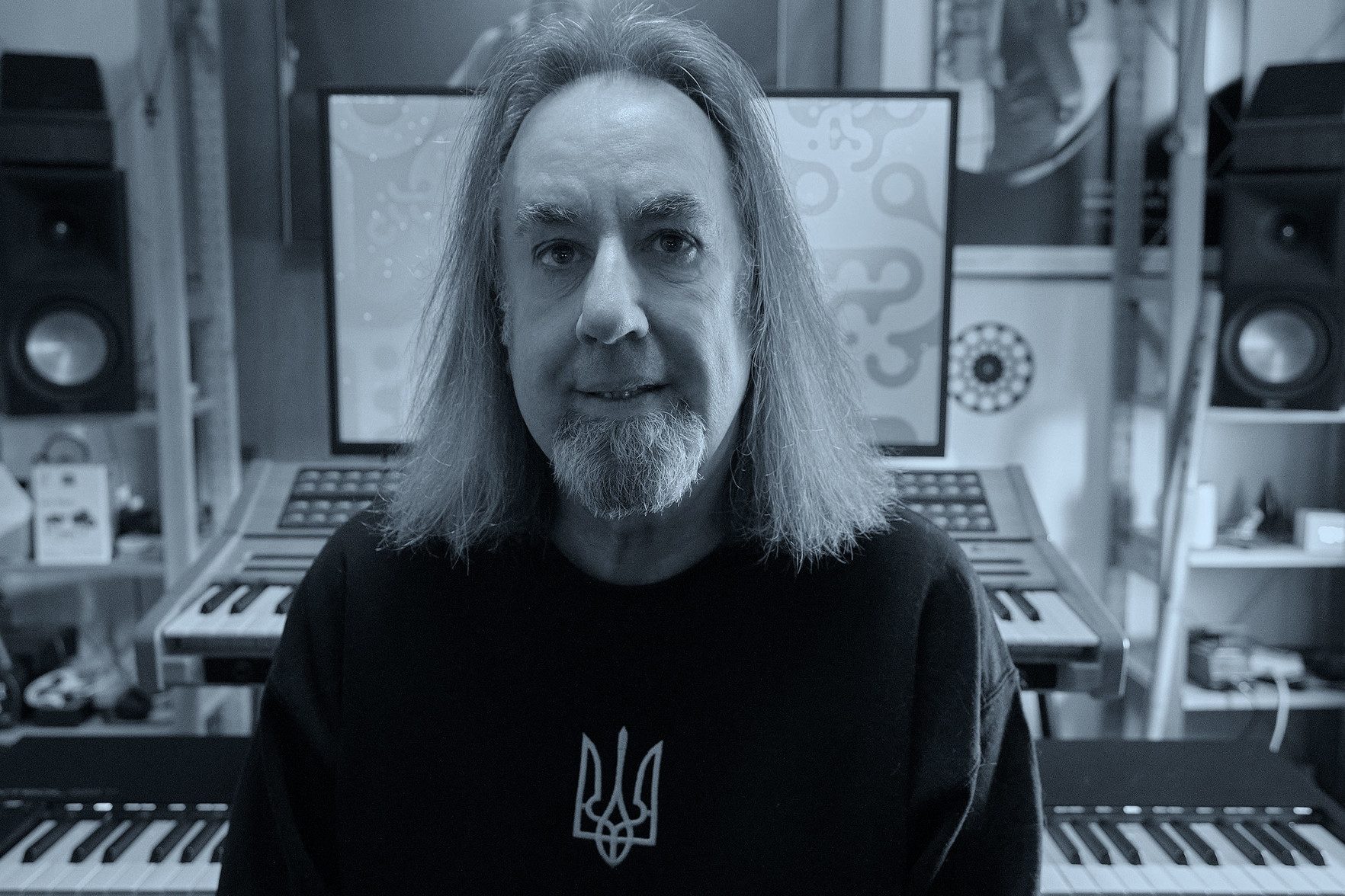 Self-portrait of moi, facing the camera. The shot is towards the speakers at the rear of the studio.

The visible keyboards are my beloved Nonlinear Labs C15 (nestled right below its dedicated monitor) and the Native Instruments Kontrol S88 mk3 MIDI controller.
