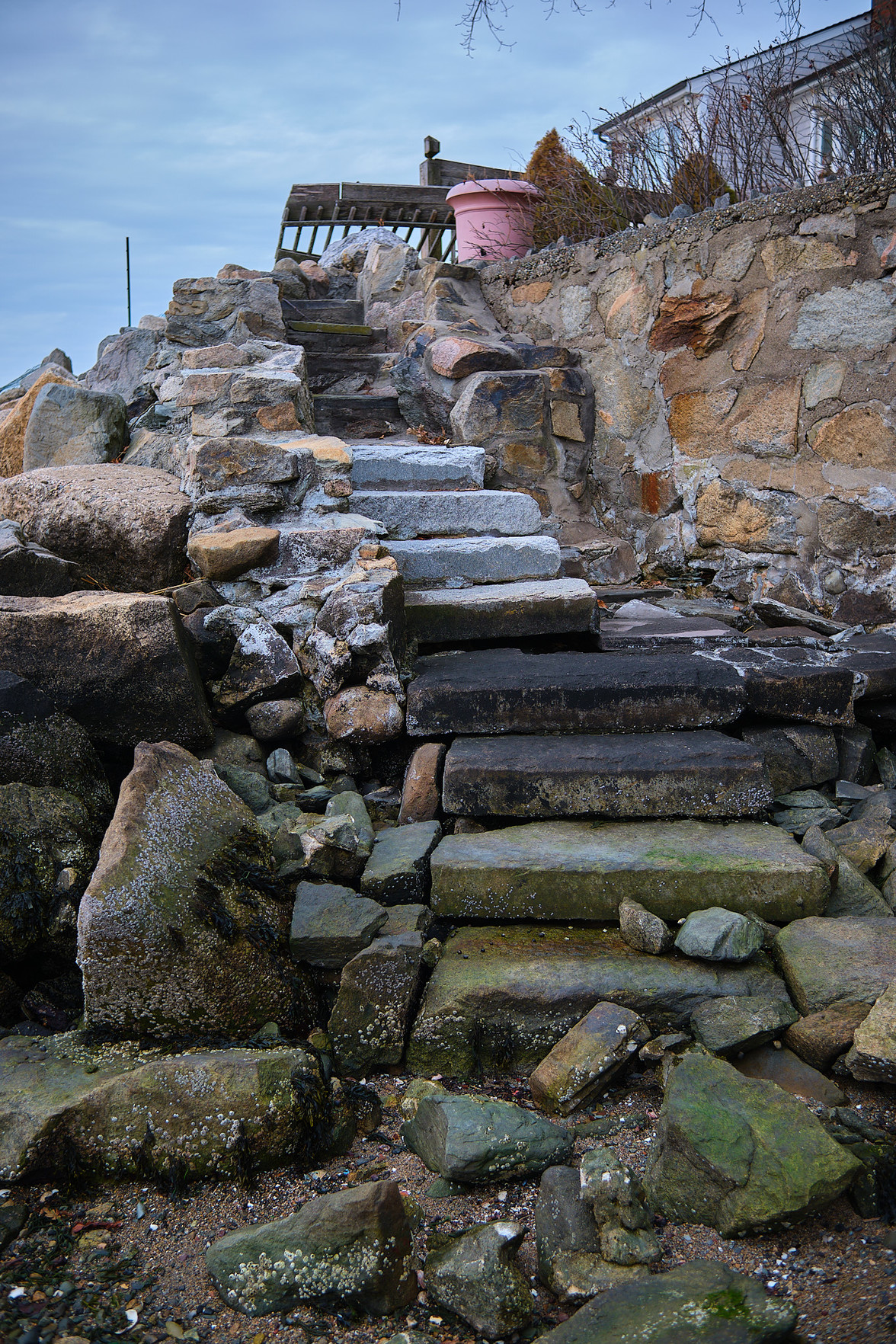 A set of stone stairs descending to the sandy cove.