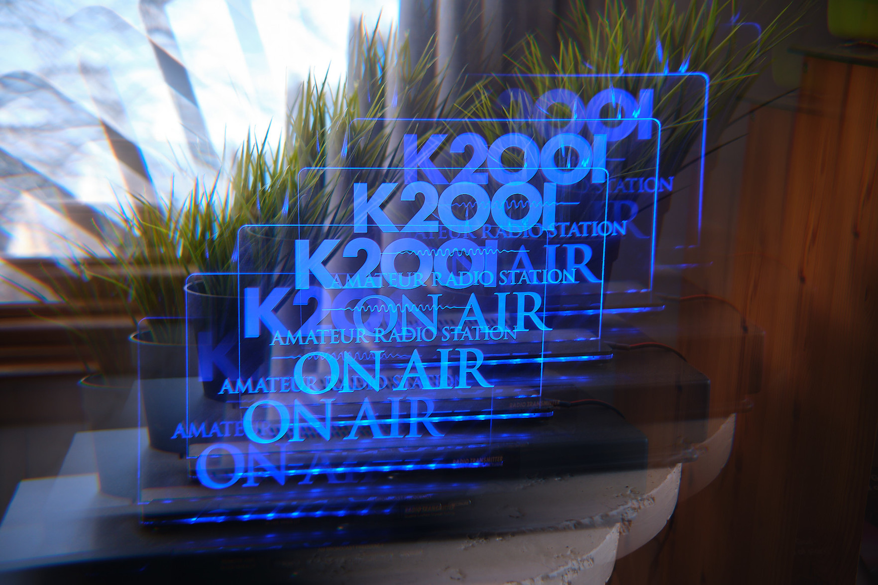 An illuminated light with my ham radio call sign, echoed by the filter.